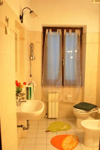 a bathroom with a sink and a toilet and a window at La Capannella in Gallicano