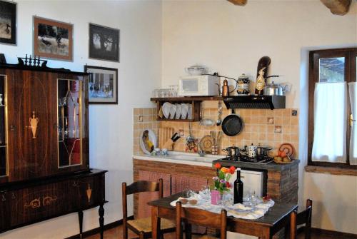 a kitchen with a table with flowers on it at La Capannella in Gallicano