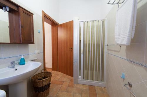a bathroom with a sink and a toilet and a shower at Casa Elena in Trapani