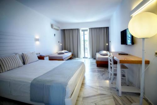 a hotel room with a bed and a desk at Sol Marina Beach Crete in Gouves