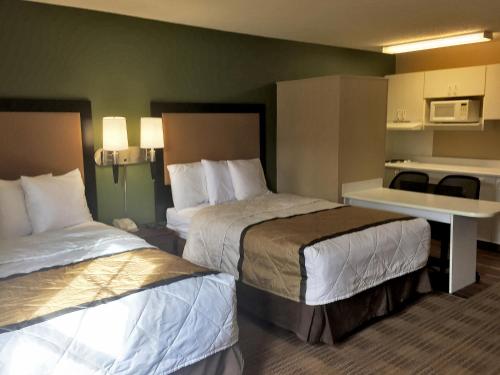 um quarto de hotel com duas camas e uma secretária em Extended Stay America Suites - Detroit - Madison Heights em Madison Heights