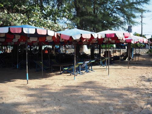 a group of umbrellas and chairs in a park at Grand Blue Condominium by Mary in Mae Pim