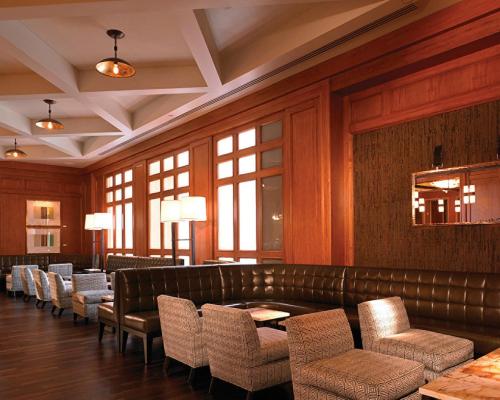a waiting room with a leather couch and chairs at Four Seasons Hotel San Francisco in San Francisco