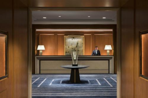 a man sitting at a desk in a hotel lobby at Four Seasons Hotel San Francisco in San Francisco