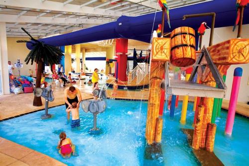 a water park with a slide and people in the water at JeffsCondos - 4 bedroom - Dunes Village Resort in Myrtle Beach