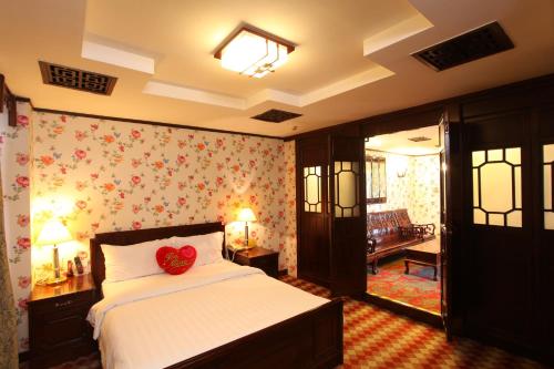 a bedroom with a bed with a red heart on it at Xin Hua Hotel Guangzhou in Guangzhou