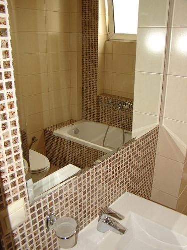 a bathroom with a tub and a sink and a toilet at Hotel Astron in Kardítsa