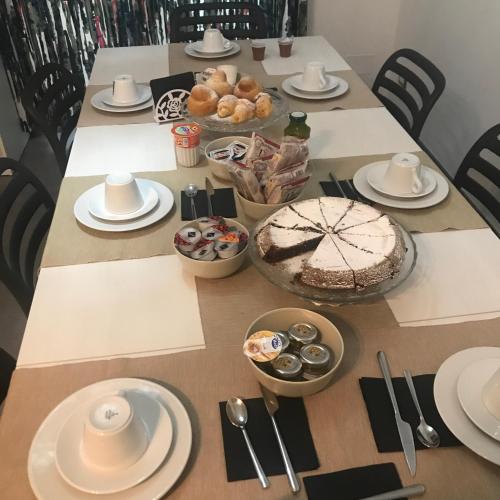 a table with a cake and other food on it at Bed&Cappuccini in Avellino
