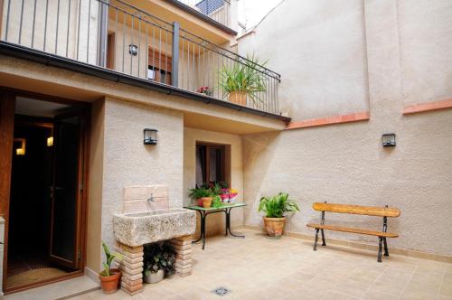 a bench sitting on a patio next to a building at Cal Blai in Móra la Nova