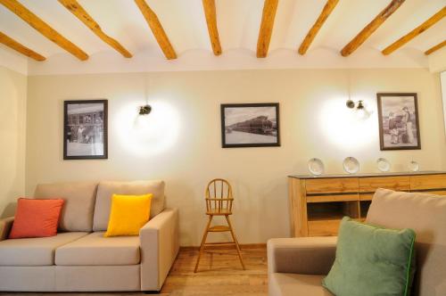 a living room with a couch and a chair at Cal Blai in Móra la Nova