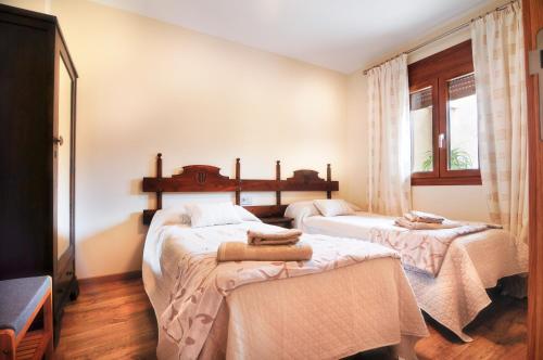 a bedroom with two beds with towels on them at Cal Blai in Móra la Nova