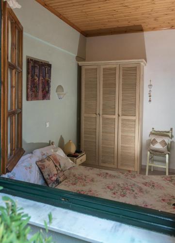 a bedroom with a bed and a large window at Kanoni Beach Apartments in Lákka