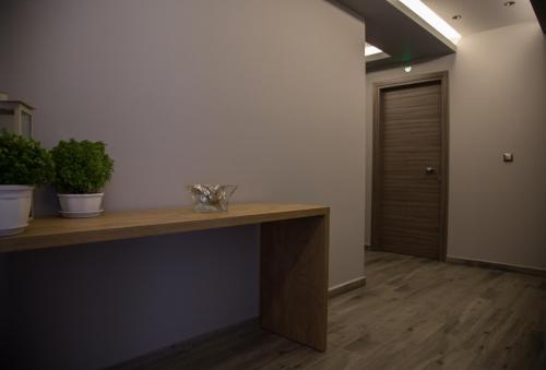 an office with a wooden desk and a door at B. U. Luxury Apartments in Asprovalta