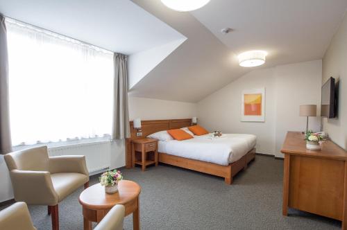 Postel nebo postele na pokoji v ubytování Hotel Pod Věží