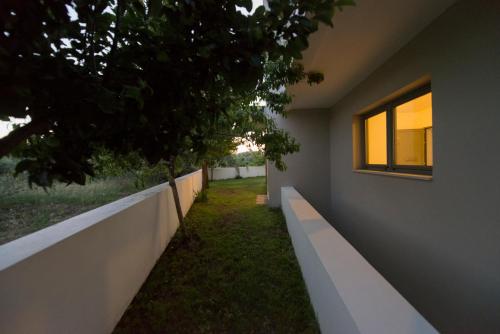 a facade of a house with a wall and a window at Villa Gonia in Gonia