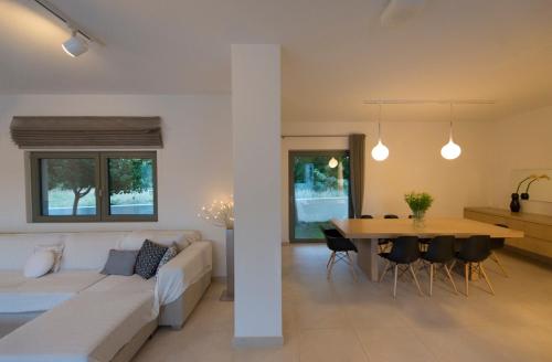 a living room and dining room with a couch and a table at Villa Gonia in Gonia