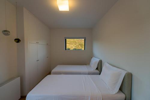 a small bedroom with two beds and a window at Villa Gonia in Gonia