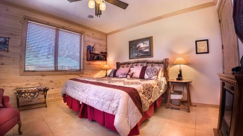 a bedroom with a bed and a chair and a window at Elktrace Bed and Breakfast in Pagosa Springs