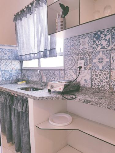 a small bathroom with a toilet and a sink at Studio Ana Laura in São Paulo