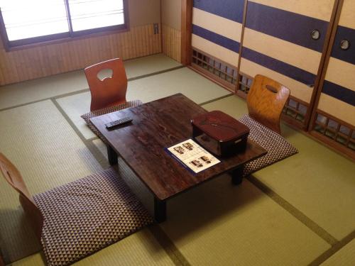 a room with a wooden table and two chairs at Hotel Edoya in Tokyo