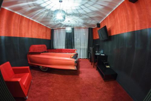 a red room with red walls and a red couch at GarageHotel in Włocławek
