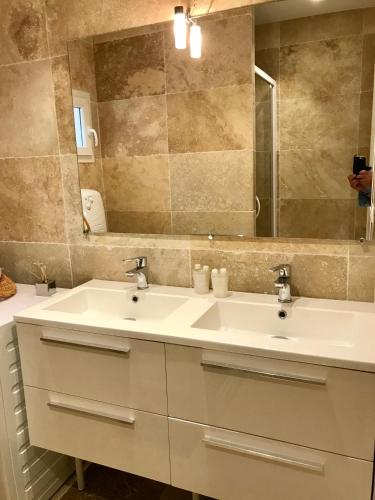 a bathroom with a white sink and a mirror at Domaine de l'Aufrene in Hyères