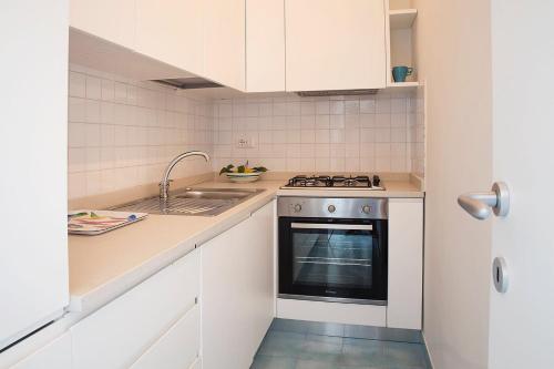 a small kitchen with a stove and a sink at Dolce Vista Apartment Amalfi Coast in Scala