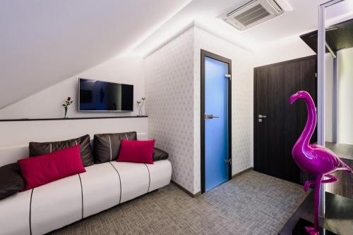 a living room with a couch and a pink flamingo at RQ Boutique & Unique Hotel in Győr