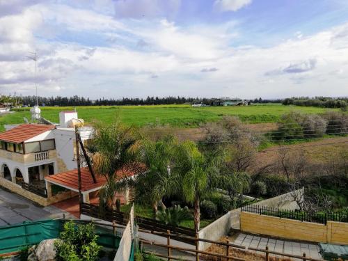 an aerial view of a house and a field at Marlen's Place near Paphos Airport in Paphos City