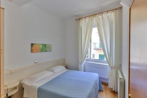 a hotel room with a bed and a window at Affittacamere Anna Michielini in Riomaggiore
