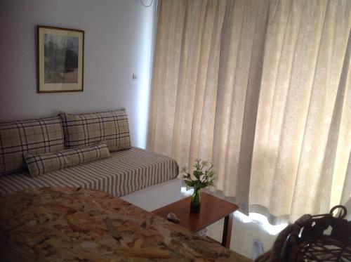 a living room with a couch and a table at Panorama in Skafidia