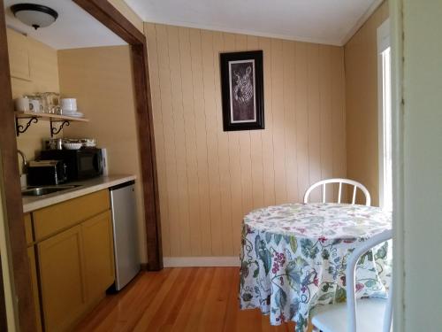 a kitchen with a table with a table cloth on it at China Creek Cottages in Willow Creek