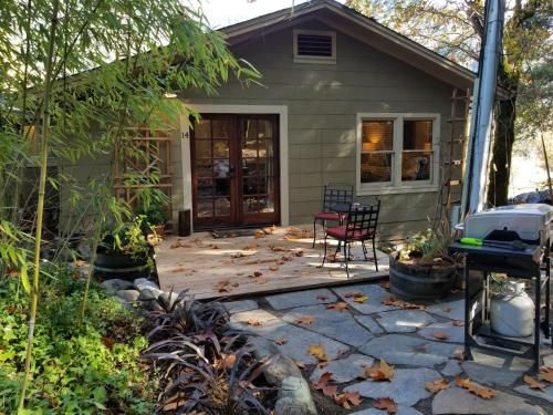 a patio in front of a house with a chair at China Creek Cottages in Willow Creek