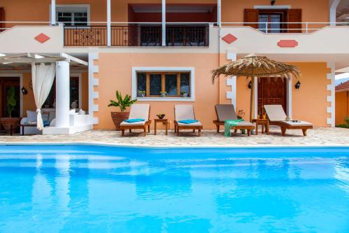 a villa with a swimming pool in front of a house at Villa Aliki in Vasiliki