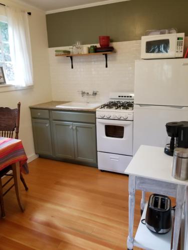 a kitchen with a white stove and a sink at China Creek Cottages in Willow Creek