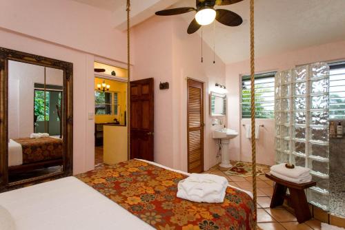 a bedroom with a swing bed and a bathroom at El Yunque Rainforest Inn in Rio Grande