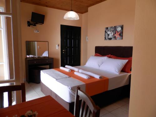 a bedroom with a bed with two towels on it at Green Villa in Agios Nikitas