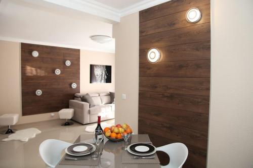 a dining room with a table and chairs and a couch at Stylish 2 Room Flat 60 meters to the beach in Nice
