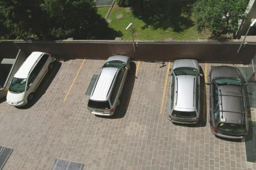 a group of cars parked in a parking lot at Hotel Domenichino in Milan