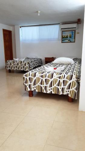 Cama o camas de una habitación en Galapagos Verde Azul