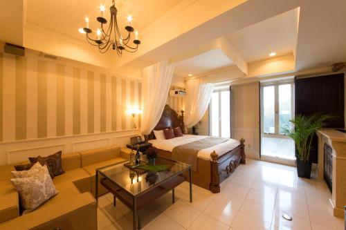 a hotel room with a bed and a couch at Canon Himeji Higashi (Adult Only) in Himeji
