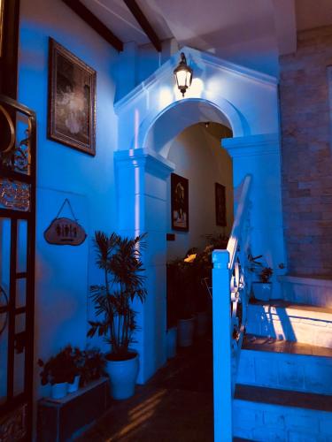 a blue room with a staircase with a light at Doc May Boutique Villa in Da Lat