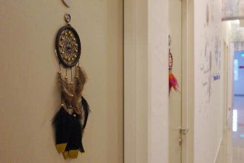 a room with a feather clock on the wall at DreamCatchers Home in Kuantan
