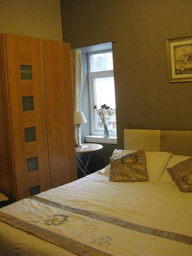 a bedroom with a large bed with a window at Kilkerran Guest House in Ayr