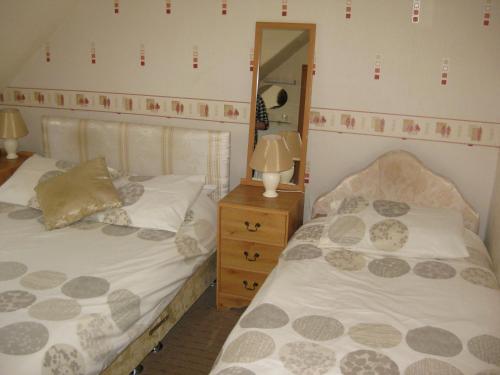 A bed or beds in a room at Kilkerran Guest House 