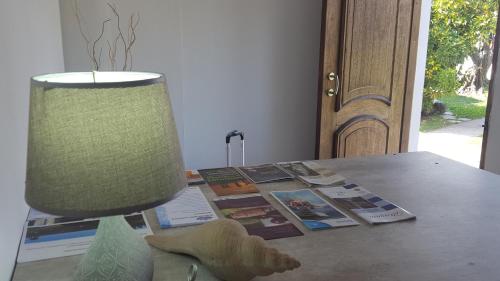 a table with a lamp and a stuffed animal on it at Bidieen Inn Uruguay in Carrasco