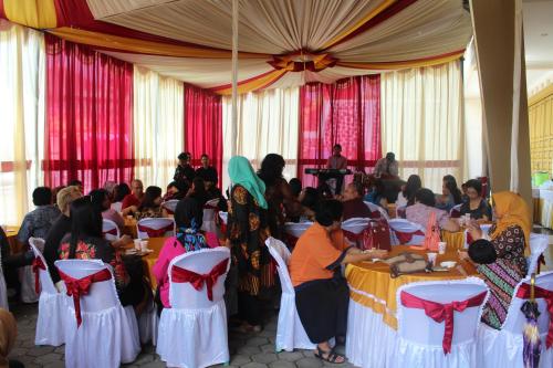 a group of people sitting at tables in a room at Aurora Guest House in Wonosobo