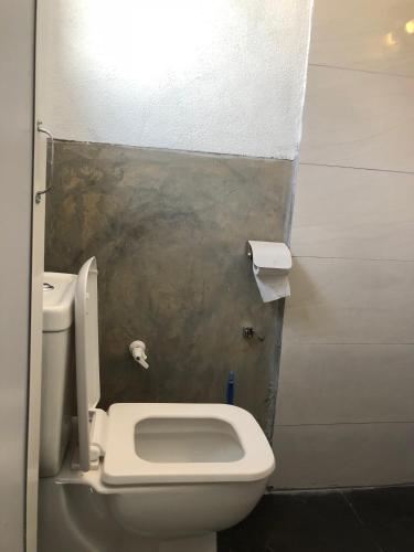 a bathroom with a white toilet in a stall at Natures Bliss Holidays in Ja-Ela