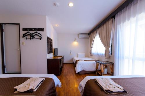 Ένα ή περισσότερα κρεβάτια σε δωμάτιο στο Hotel Patina Ishigakijima