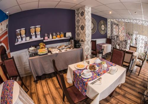a dining room with two tables and a counter at Los Leones Hotel Boutique in Arequipa